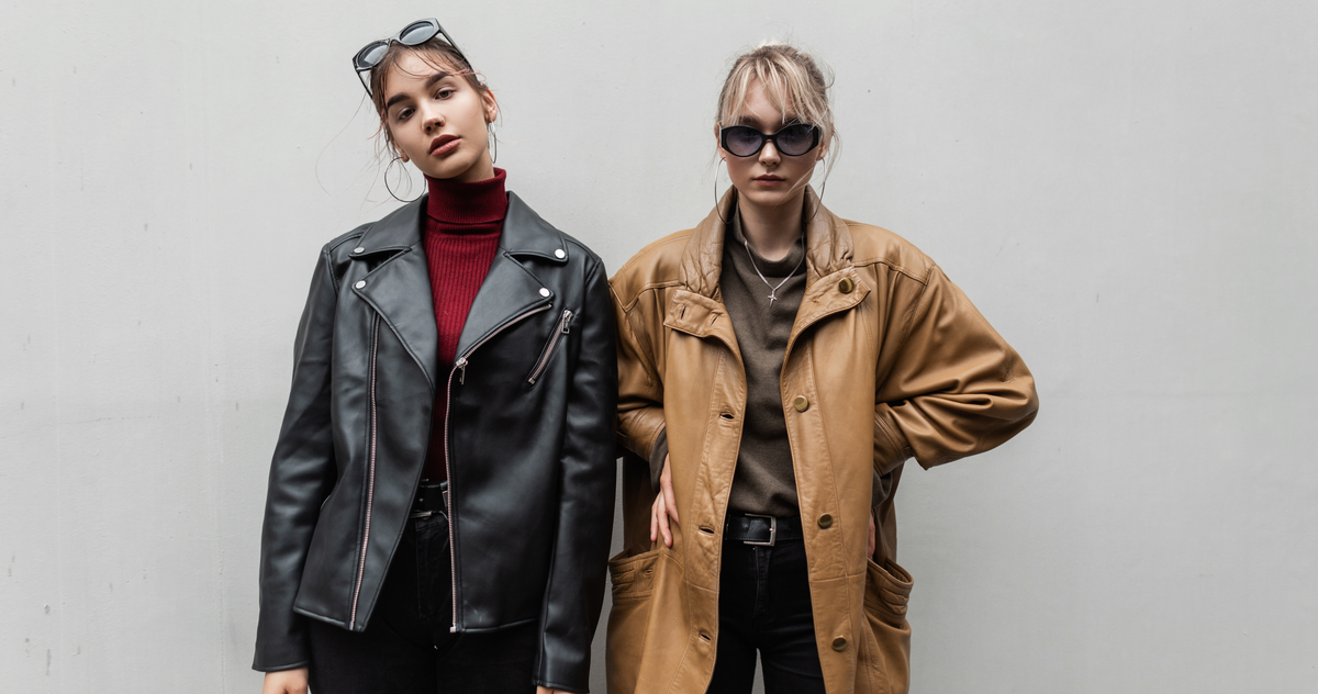 Two women wearing coordinated statement jackets and layered outfits