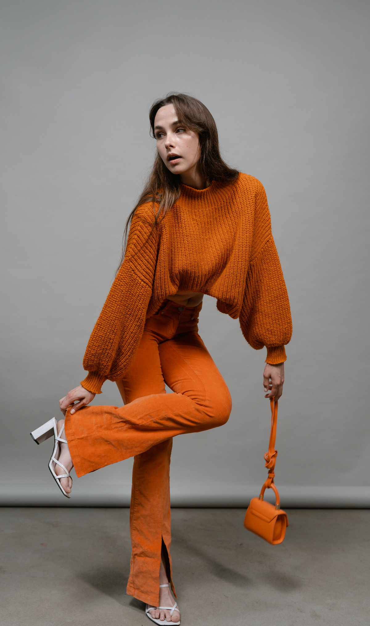 Model wearing a coordinated textured knit set with a sweater and flared trousers