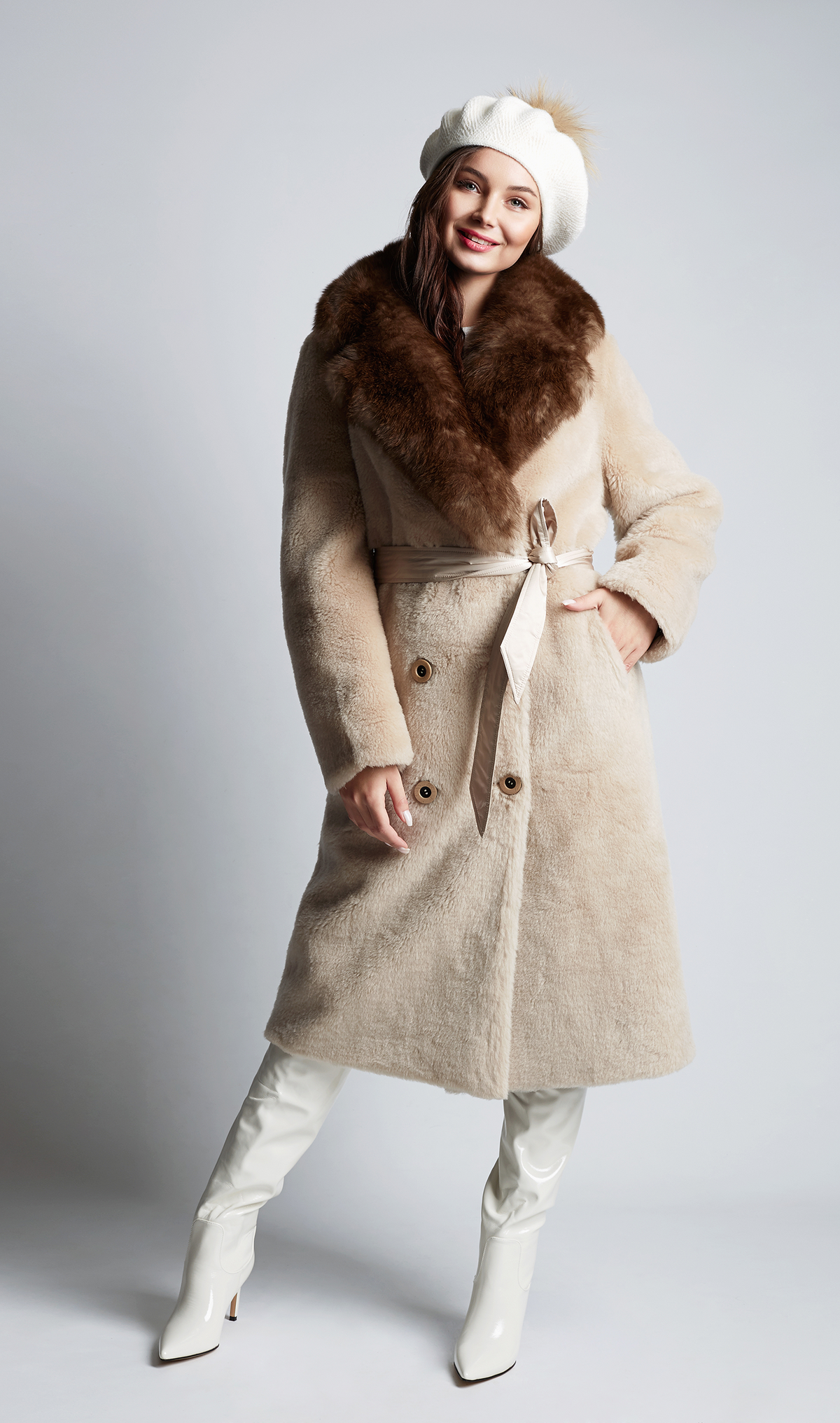 Model wearing a textured wrap coat with a defined waist and statement collar