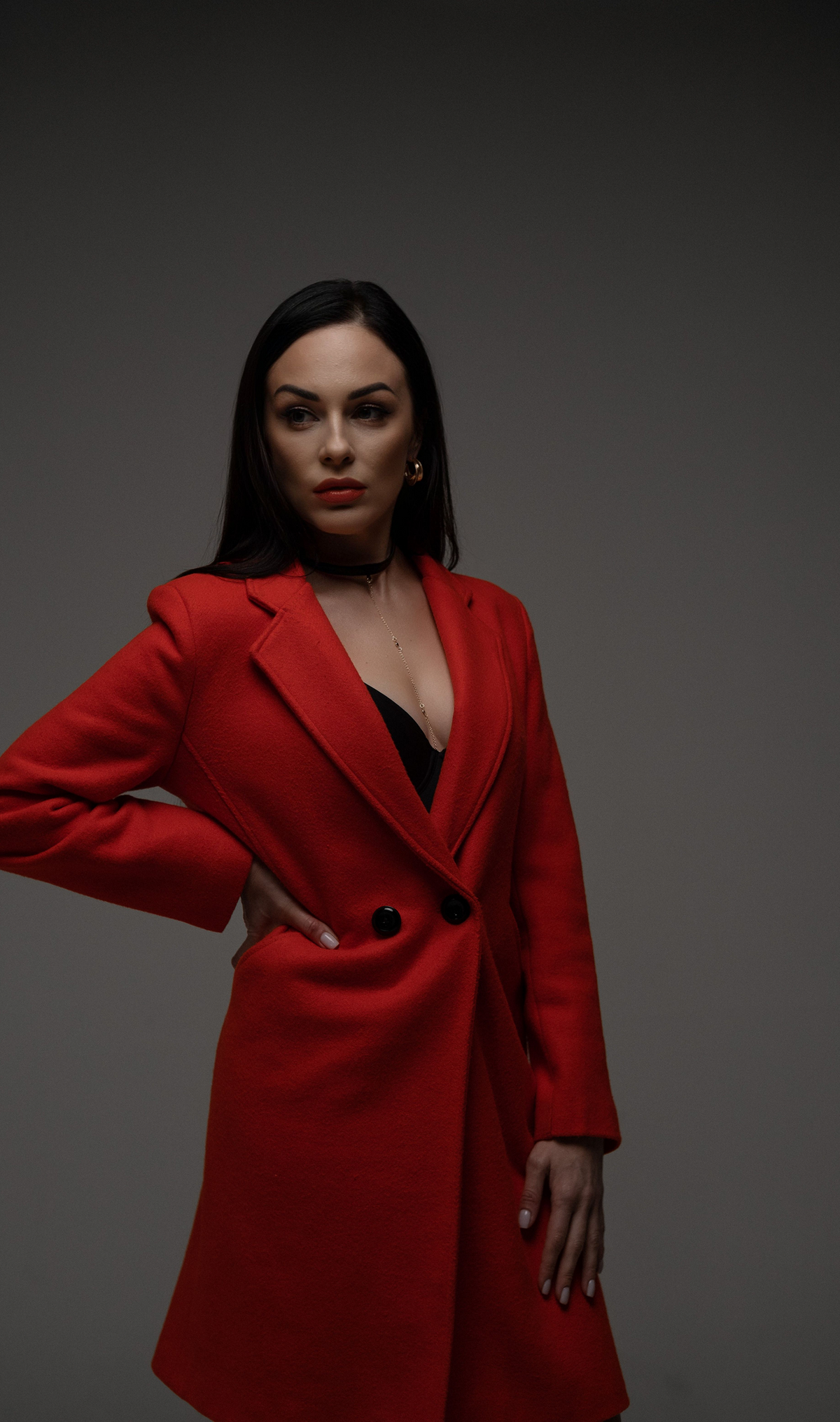 Model wearing a double breasted coat with a sculpted lapel and tailored waist
