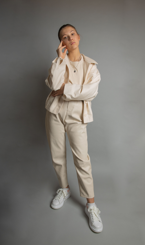 Model wearing a utility jacket set with a relaxed overshirt and straight-leg trousers