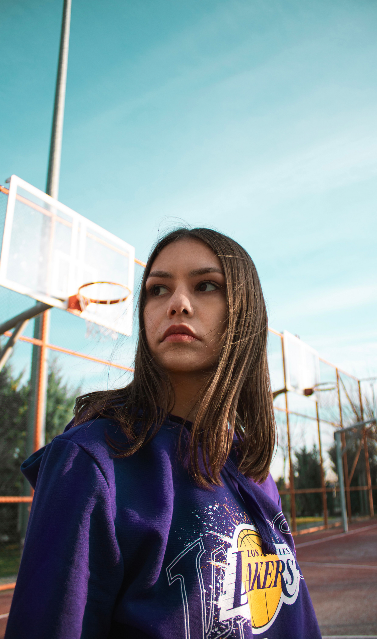 Model wearing a court graphic tee with bold athletic-inspired front artwork