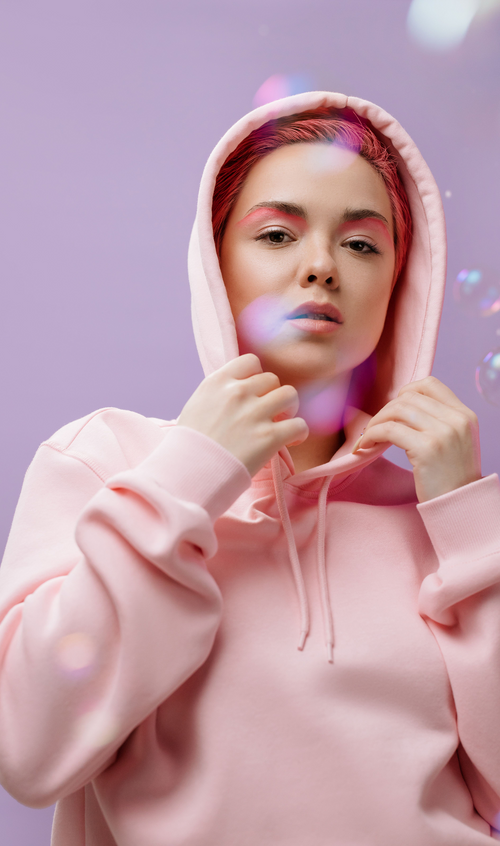 Model wearing a soft essential hoodie with a relaxed silhouette and drawstring hood