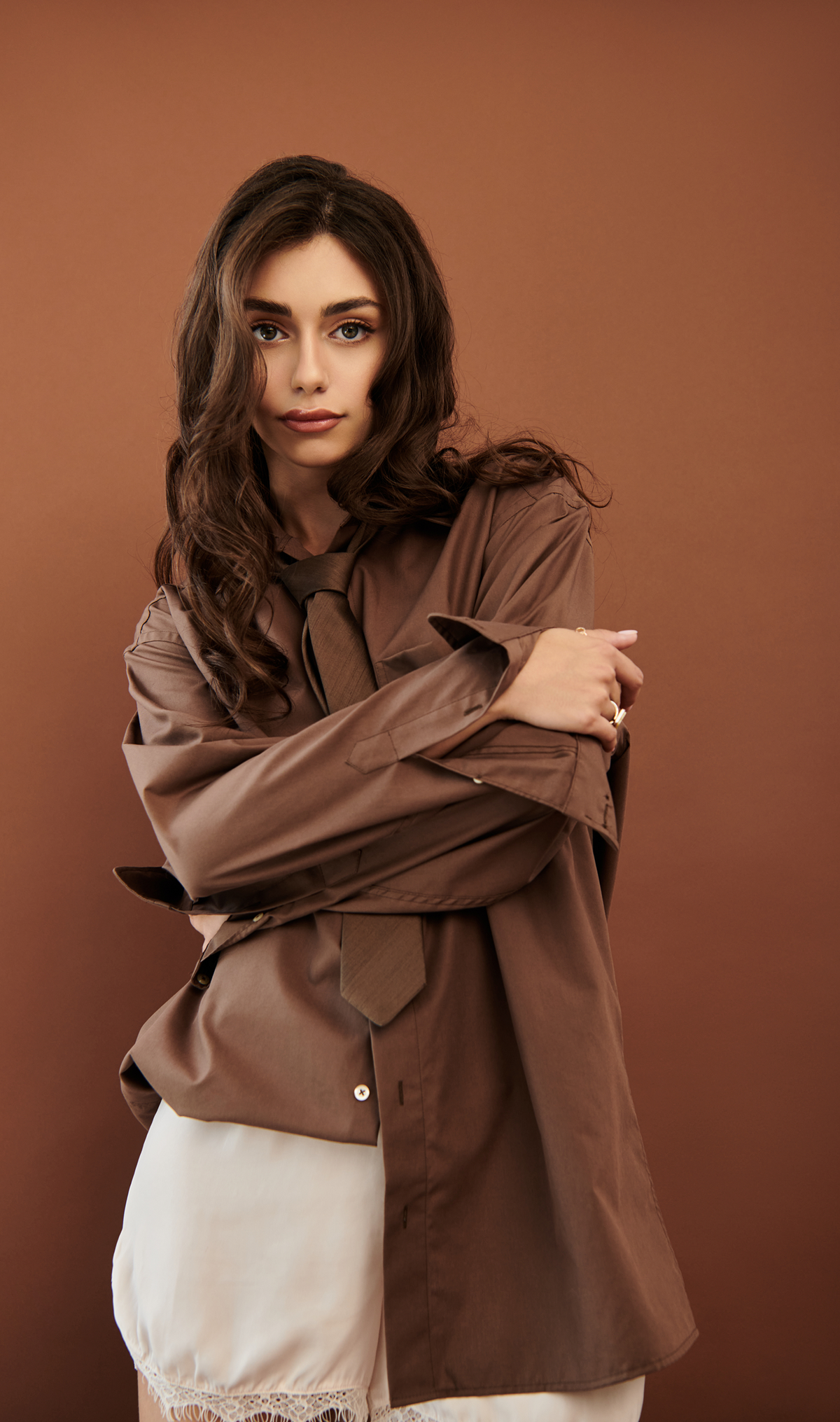 Model wearing a longline structured utility overshirt with button front and oversized pockets