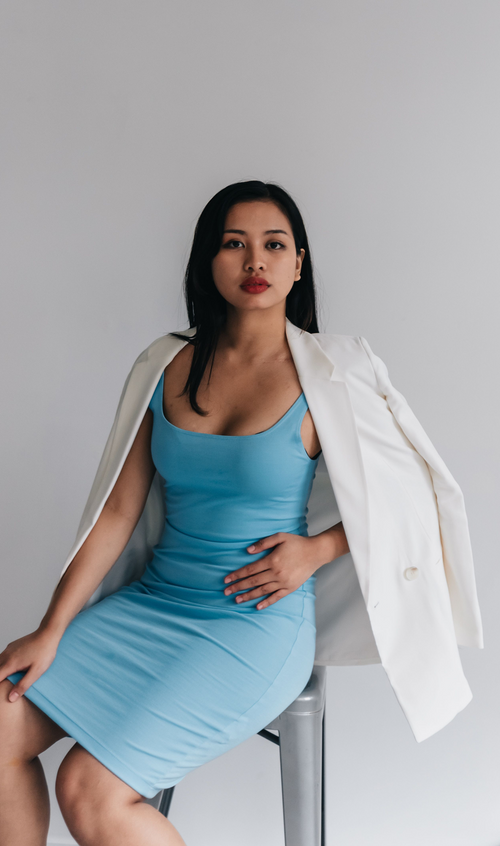 Model wearing a refined slip dress layered with a tailored jacket