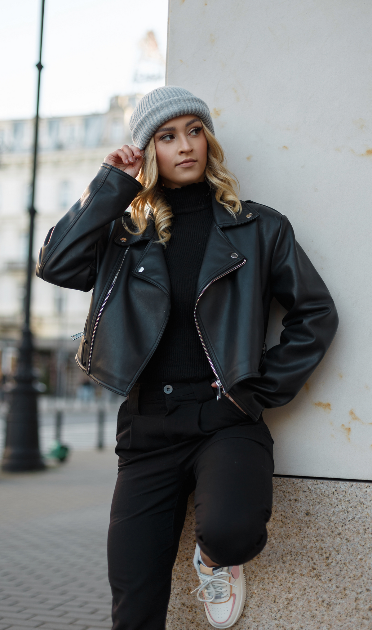 Leather moto jacket with asymmetrical zip front, notched lapels, and zip pockets