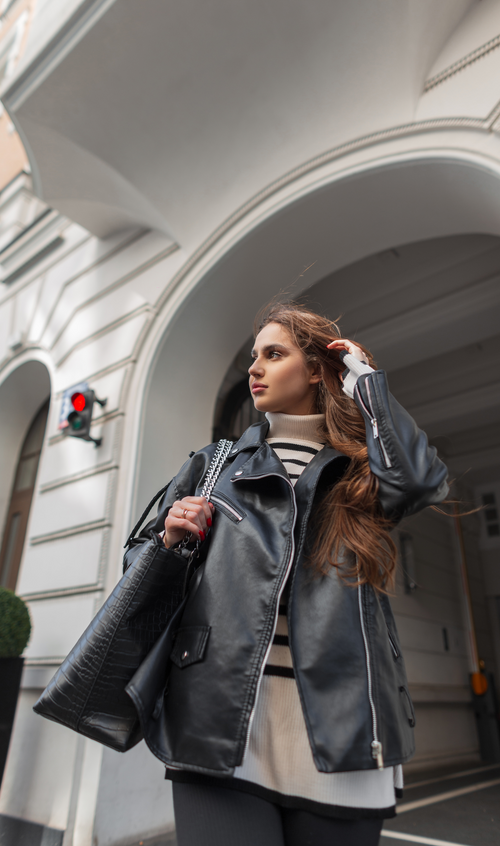 Oversized moto jacket with wide lapels, angled zip details, secure pockets, and adjustable hem