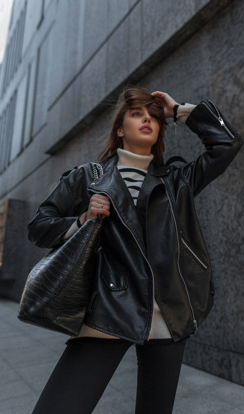 Asymmetric moto jacket with wide lapels, angled zip front, secure pockets, and adjustable hem