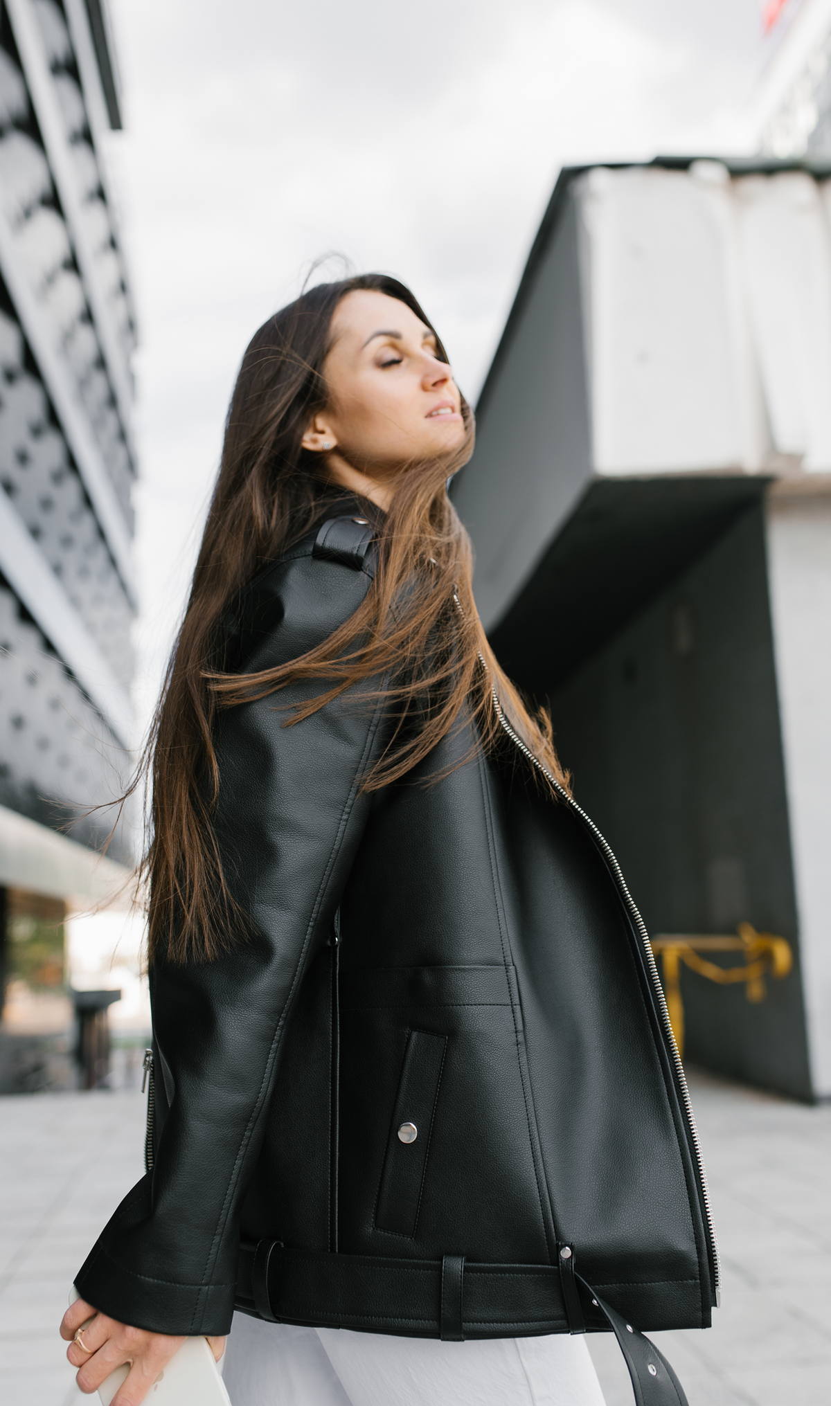 Belted leather jacket with a stand collar, full-length zip front, and secure pockets