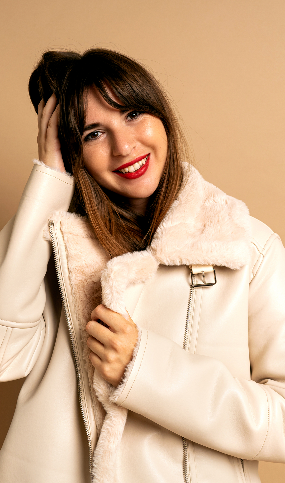 Shearling aviator coat with plush collar, belted front, secure zip pockets, and structured silhouette