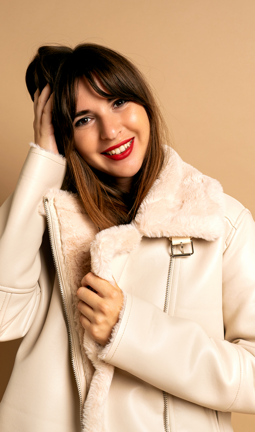 Shearling aviator coat with plush collar, belted front, secure zip pockets, and structured silhouette