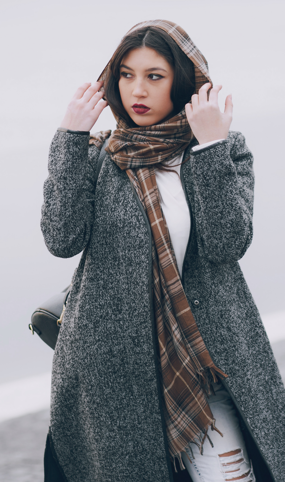 Fringed plaid muffler with soft woven texture, classic pattern, and effortless wrap styling